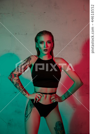 Tattooed girl in black lingerie cropped view Tattooed girl in black lingerie cropped view 44618552