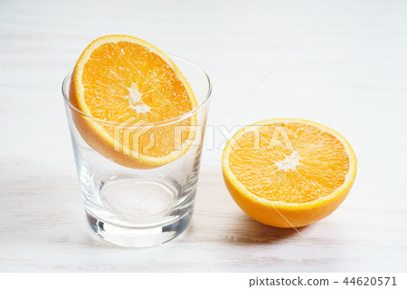 Fresh sliced orange with glass Fresh sliced orange with glass 44620571