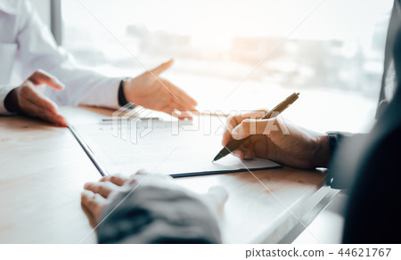 Client signing a real estate contract on desk 44621767
