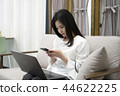 Smartphone while working on laptop 44622225