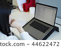 Looking at a notebook screen 44622472