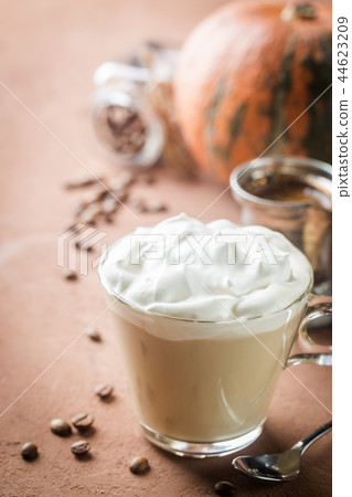 Pumpkin latte with whipped cream 44623209