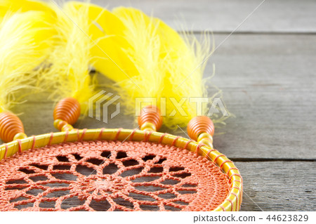 Orange yellow dream catcher on gray 44623829
