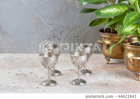 Vintage four silver goblet and green plants Vintage four silver goblet and green plants 44623841