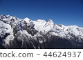 Snowy montain peaks and blue sky photo 44624937