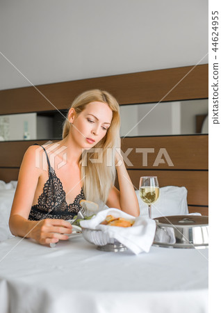 woman having lunch in hotel room on vacations 44624955