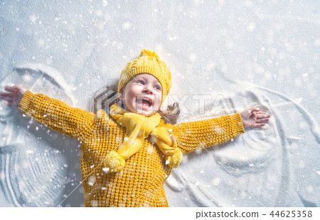 Kid making snow angel. 44625358