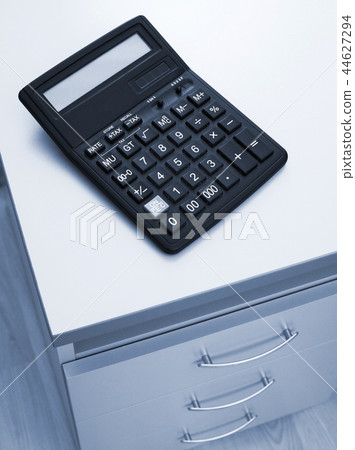 calculator on a table at office 44627294