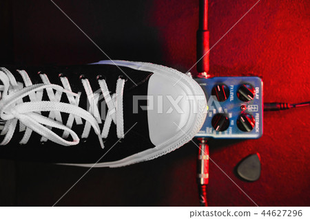 Guitar pedals and footswitch inside recording room. Close up of guitar pedals and musician's foot 44627296