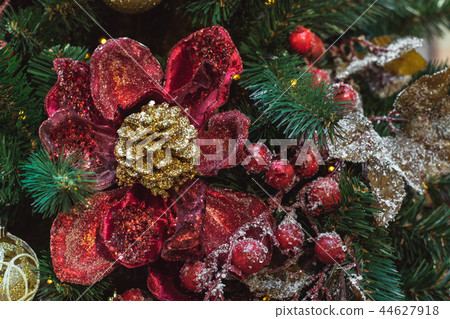 Christmas tree with red and golden flower decors. Christmas tree with red and golden flower decors. 44627918