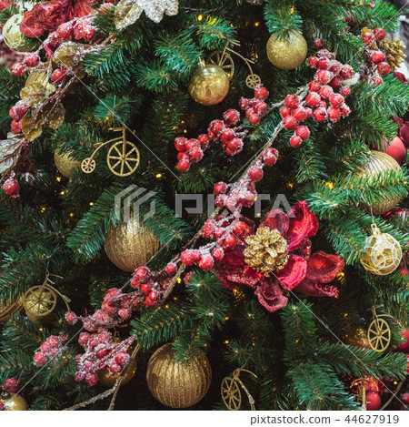 Christmas tree with red and golden flower decors.  44627919