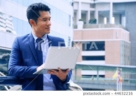 Asian businessman carry notebooks and act thinking 44632216