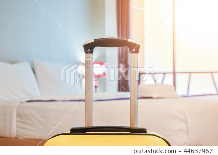 Suitcase or Luggage bag in a modern hotel room prior to checkin or checkout Suitcase or Luggage bag in a modern hotel room prior to checkin or checkout 44632967