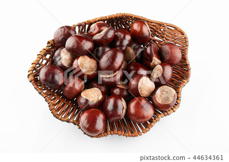 Wicker tray with chestnuts on white background 44634361