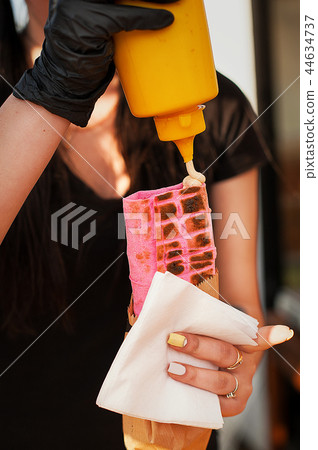 Preparation of shawarma. The cook pours sauce. Preparation of shawarma. The cook pours sauce. 44634737