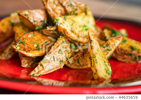 Baked potato wedges with dill and spices close Baked potato wedges with dill and spices close 44635659