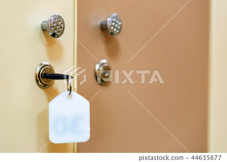 Wooden doors with key in sports gym locker room 44635677