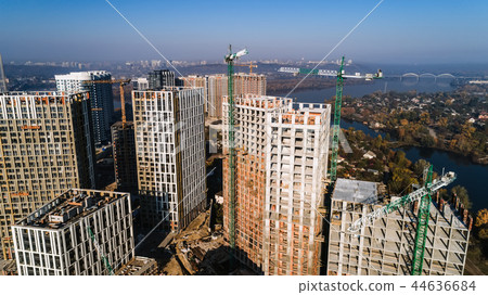 Aerial view of landscape in the city with under construction buildings and industrial cranes Aerial view of landscape in the city with under construction buildings and industrial cranes 44636684