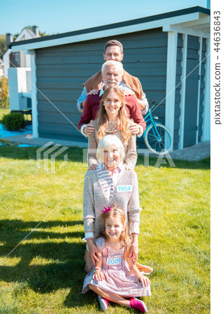 Happy little girl sitting on the foreground 44636843