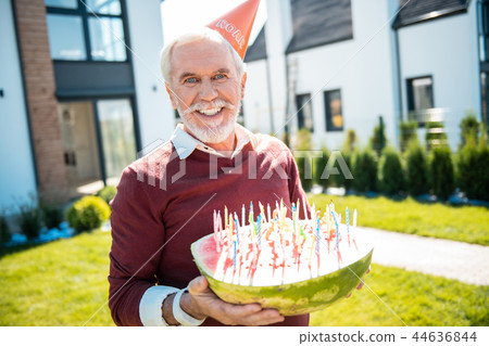 Positive delighted senior male person poising on camera Positive delighted senior male person poising on camera 44636844