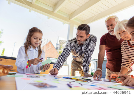 Attentive brunette male looking at his daughter Attentive brunette male looking at his daughter 44636941