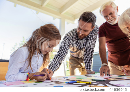 Pleased little girl creating her family tree 44636943