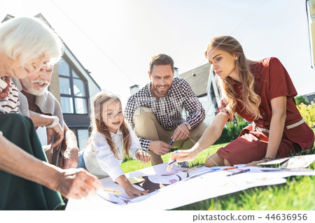 Positive delighted people drawing their family tree Positive delighted people drawing their family tree 44636956
