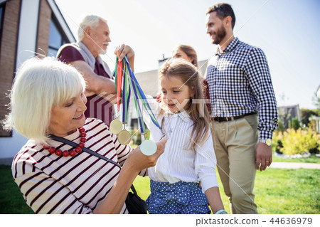 Happy retired woman communicating with her granddaughter Happy retired woman communicating with her granddaughter 44636979