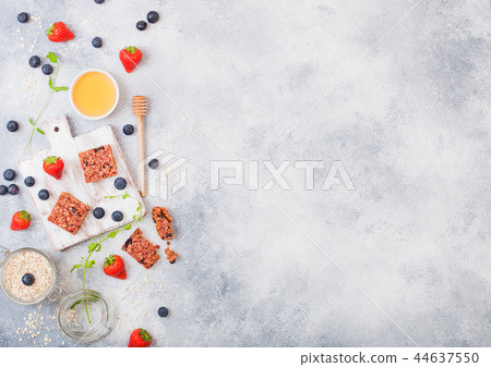 Organic cereal granola bar with berries on board  44637550