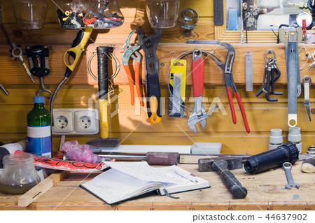 Wooden workbench at workshop. Lot of different tools for diy and repair works. Wood messy table with 44637902