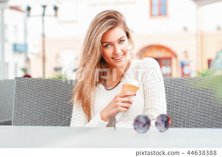 Happy woman eating ice-cream, outdoor Happy woman eating ice-cream, outdoor 44638388