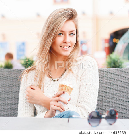 Beautiful girl resting in a summer cafe. Beautiful girl resting in a summer cafe. 44638389