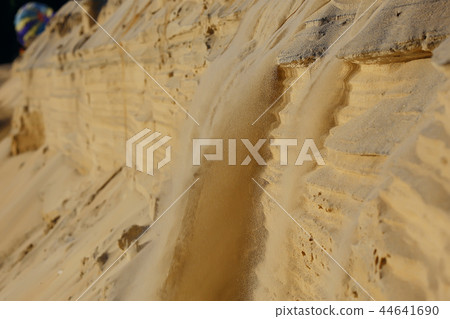 the texture of the sand is drowned by sand dunes / sand avalanche is showered off the dune, an unusual texture of sand 44641690