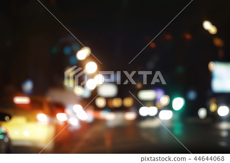view of car in traffic jam / rear view of the landscape from window in car, road with cars, lights and the legs of the cars night view 44644068