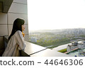 Smiling looking out of the building from the balcony 44646306