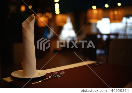 serving in the restaurant, fork and knife / interior view of the restaurant with a table served knife and fork on the table in a cafe 44650254