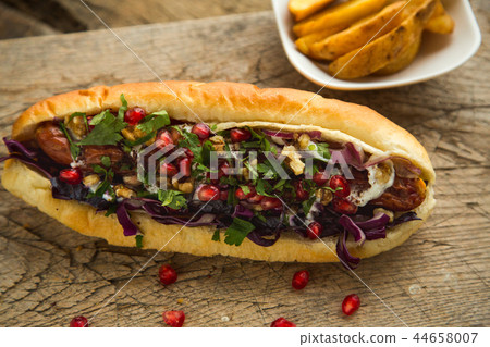 French bun sandwich with sausage and onion. French bun sandwich with sausage and onion. 44658007