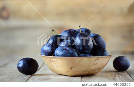 Selective focus. Ripe blue plums with water drops 44660295