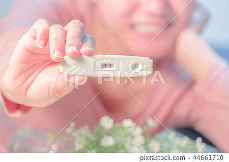 positive pregnancy test result hold on happy women 44661710