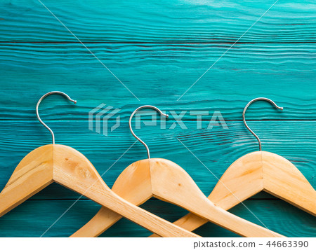 Wooden hangers on green background. Concept Wooden hangers on green background. Concept 44663390