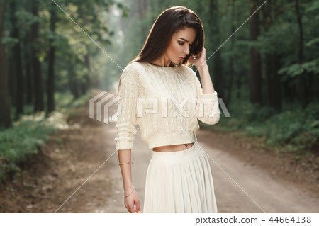Portrait of a pretty woman in a white sweater 44664138