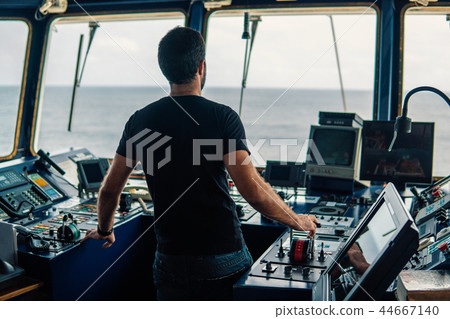 Marine navigational officer is maneuvering ship or vessel 44667140