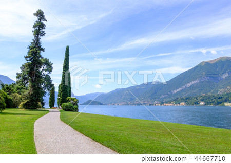 Road and grass field on shore of Lake Como Road and grass field on shore of Lake Como 44667710