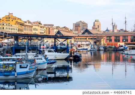 Ships parked in Porto Antico at sunset 44669741
