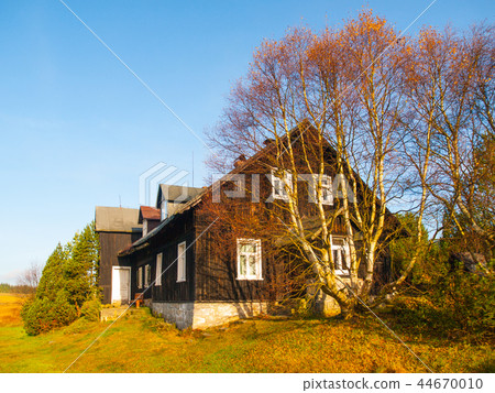 Wooden hut in Jizerka village. Sunny autumn day. Jizera Mountains, Czech Republic 44670010