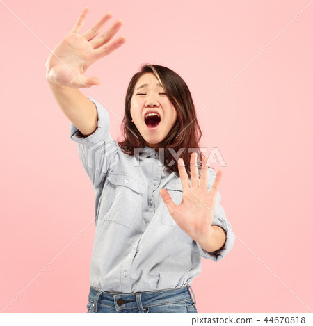 Portrait of the scared woman on pink 44670818