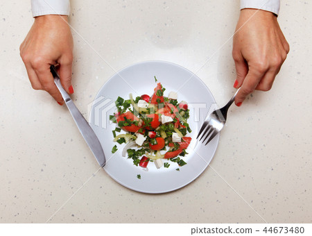 salad for visitor which holds knife and fork salad for visitor which holds knife and fork 44673480