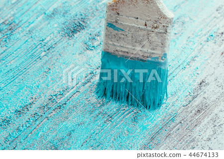closeup hand use brush paint white blue on surface closeup hand use brush paint white blue on surface 44674133