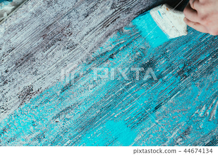 closeup hand use brush paint white blue on surface closeup hand use brush paint white blue on surface 44674134