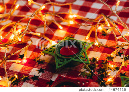 candle on red checkered tablecloths and garland candle on red checkered tablecloths and garland 44674516